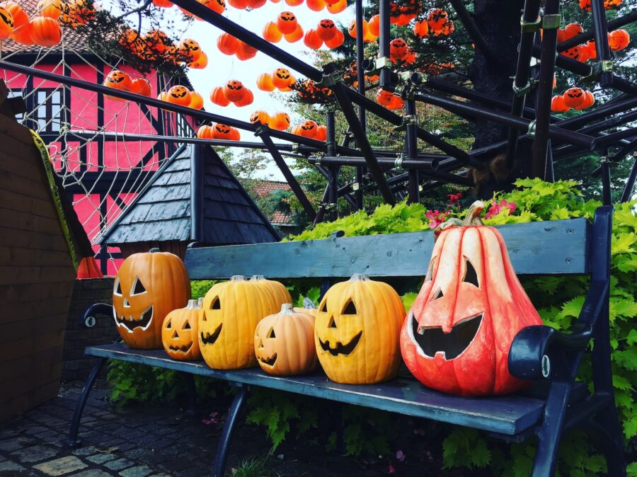 a bench with carved pumpkins sitting on top of it